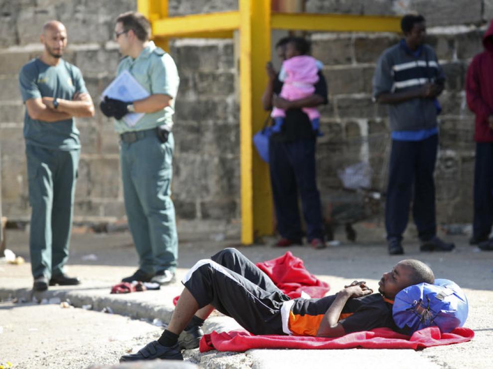 Un inmigrante descansa en el suelo tras ser trasladado al puerto de Tarifa