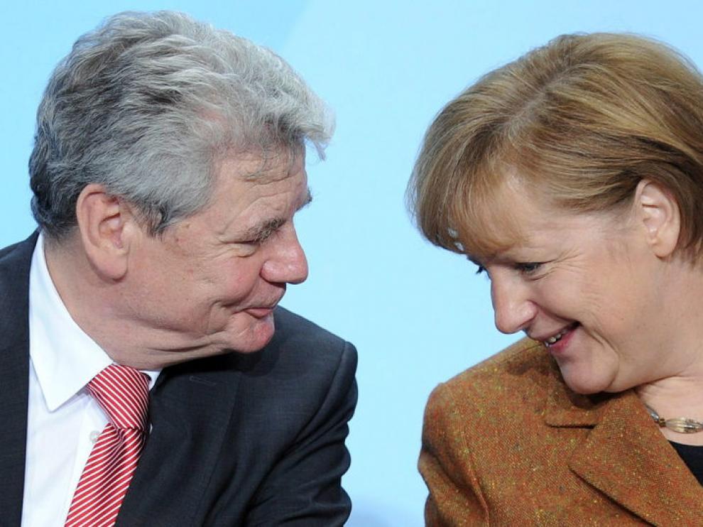 La canciller alemana, Angela Merkel, conversa con el pastor luterano, Joachim Gauck.