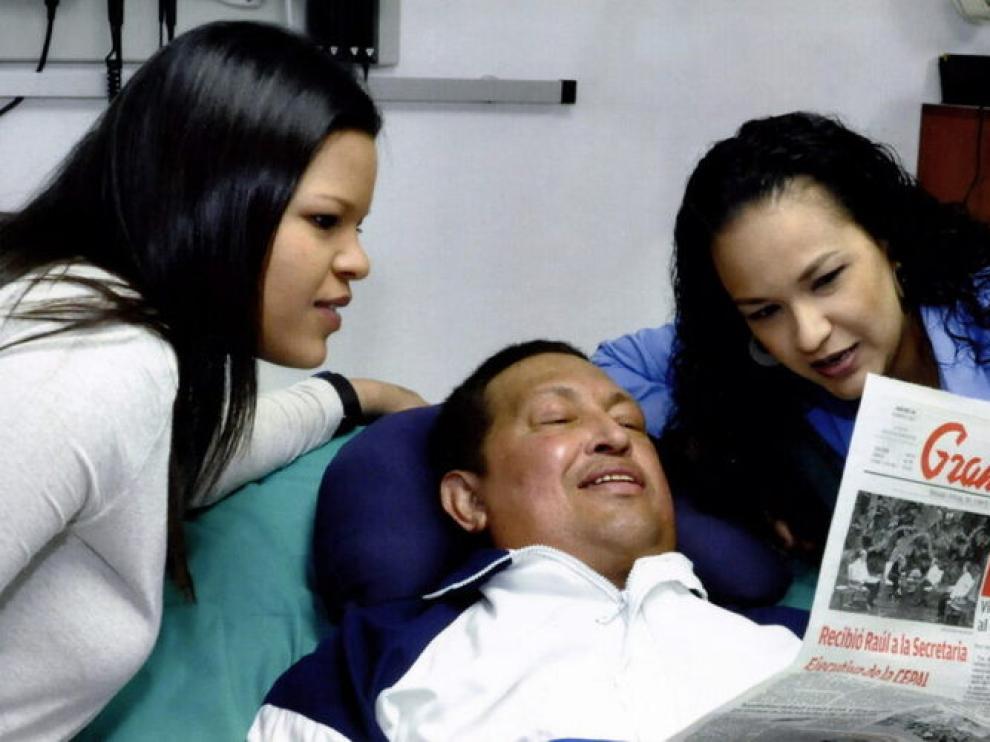 El presidente Chávez, junto a dos de sus hijas y un ejemplar del diario 'Gramna'