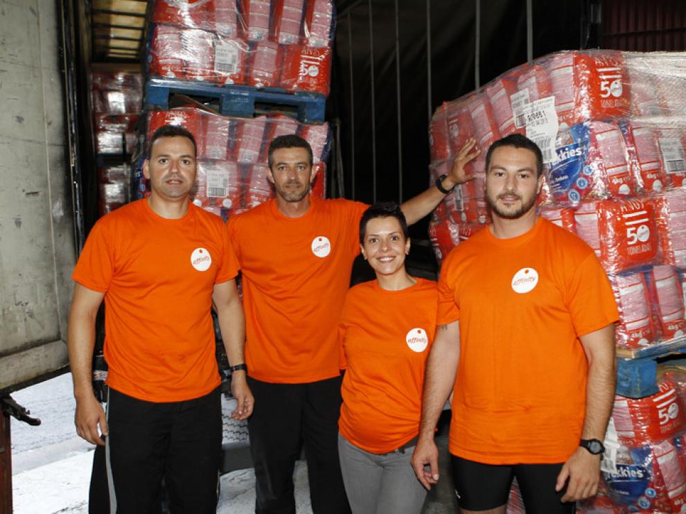 Varios voluntarios, con el pienso donado