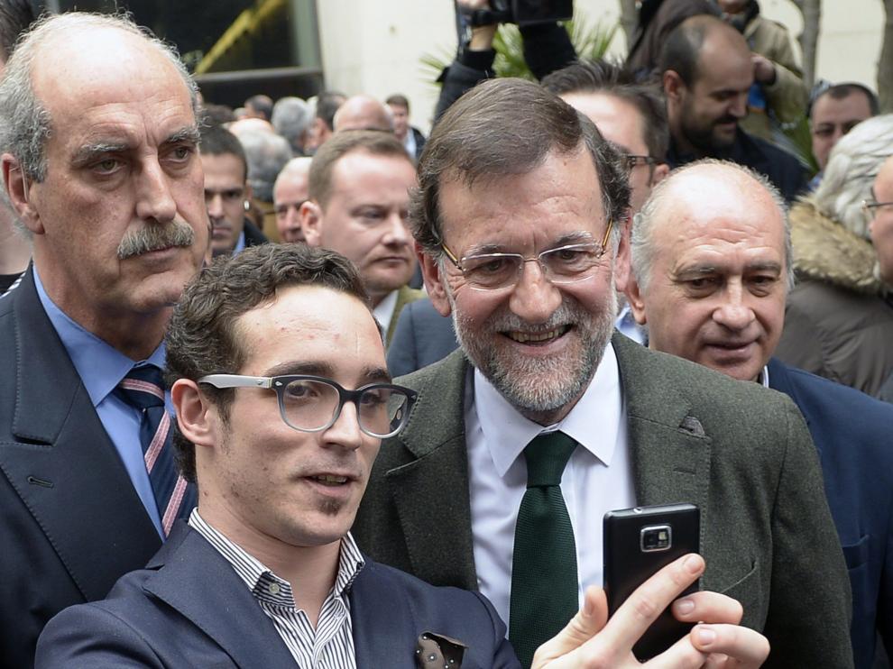 Un militante del PP se hace una foto con Rajoy