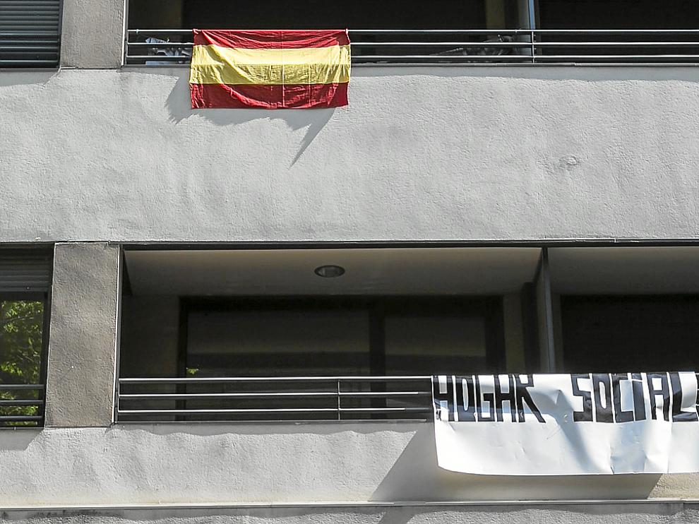Una bandera de España y un cartel que anuncia el "hogar social" colgaban ayer de la fachada del edificio, en Compromiso de Caspe.