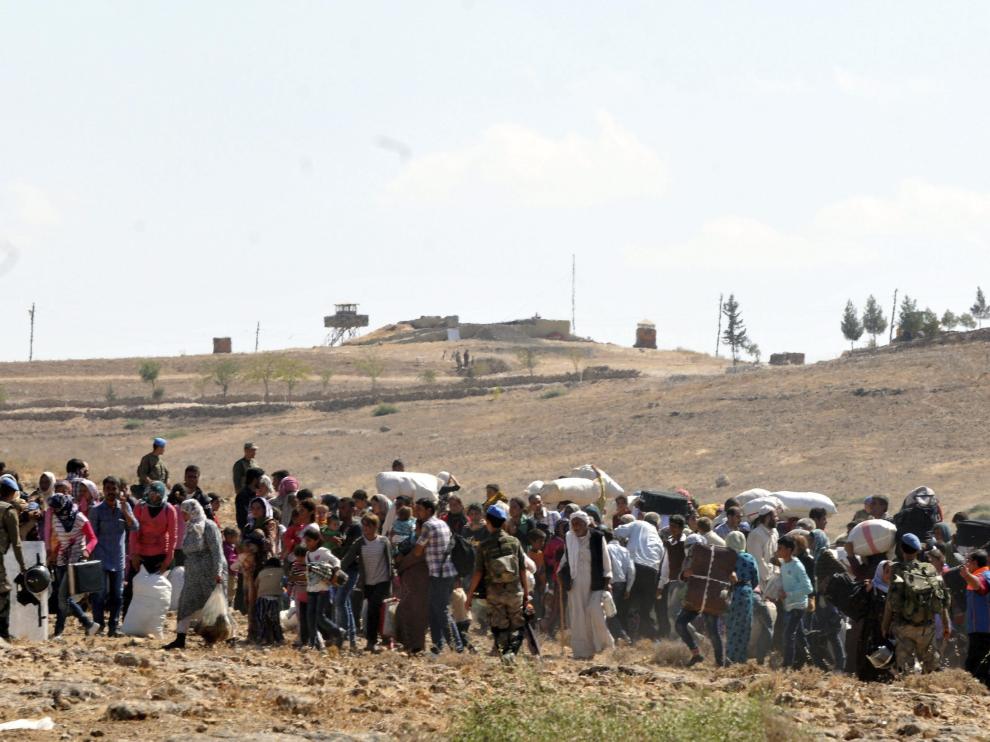 Refugiados sirios, en la frontera con Turquía, huyendo del Estado Islámico