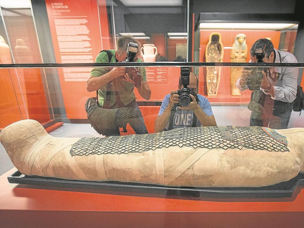 Tres fotógrafos, ante la momia de Pauiamen, hallada en Tebas, y datada entre los años 712 y 525 antes de Cristo.
