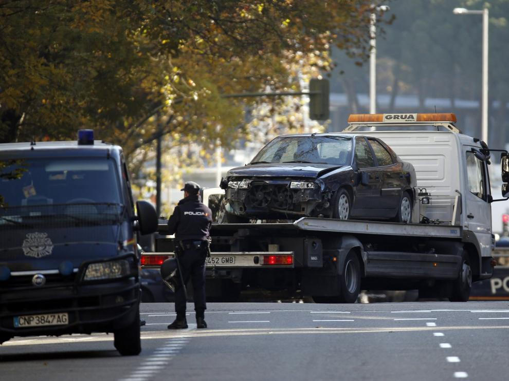 Una grúa se lleva el coche de la sede del PP