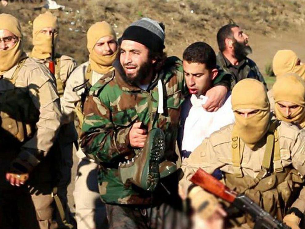 Milicianos del EI con el supuesto piloto jordano capturado