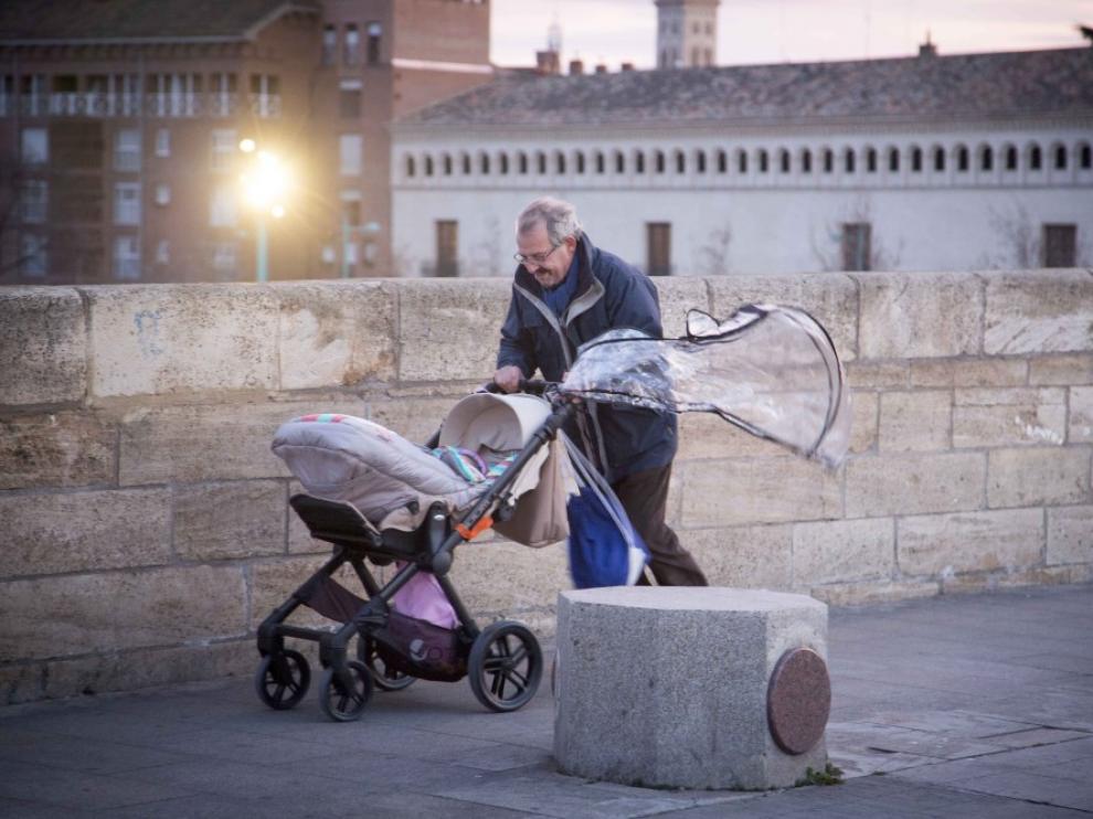 Un viandante luchando contra el fuerte viento