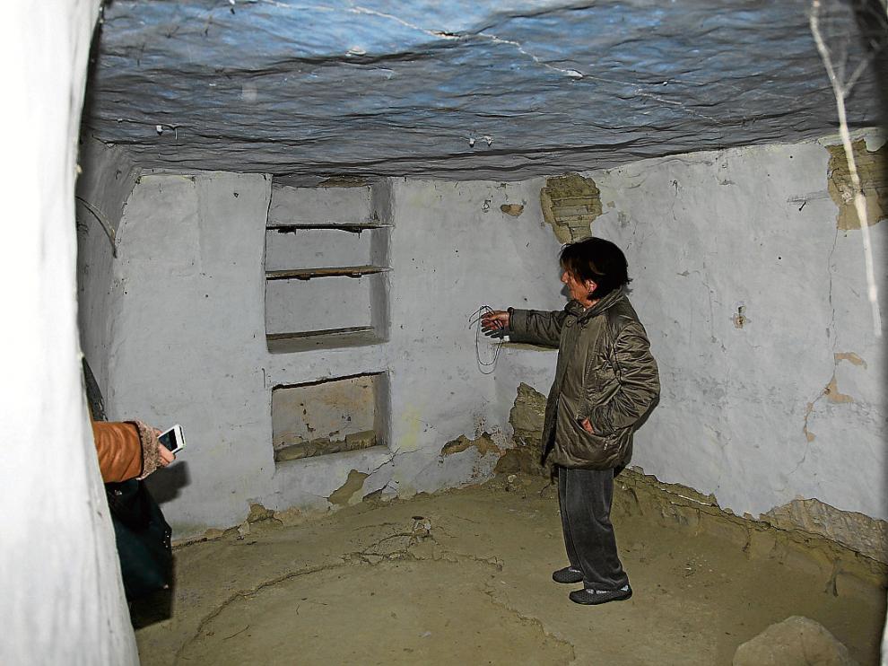 Rosa Gracia muestra las baldas colocadas en una habitación de una casa-cueva de Alcalá.