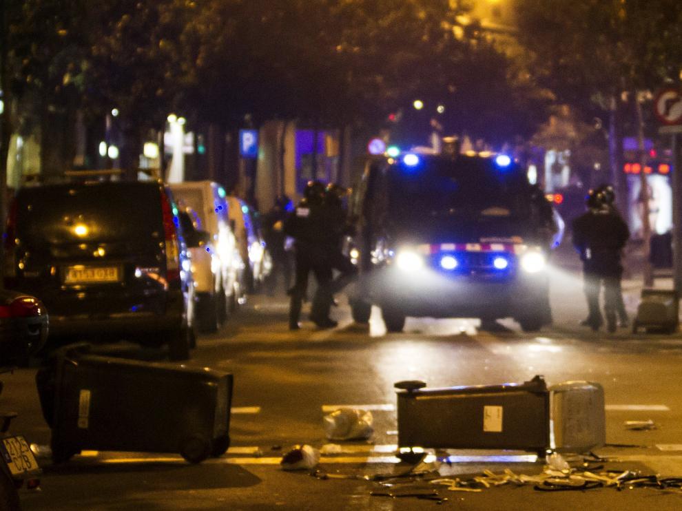 Varios contenedores tirados en el barrio de Graciá en Barcelona en el tercer día de protestas por el desalojo del "banco expropiado".
