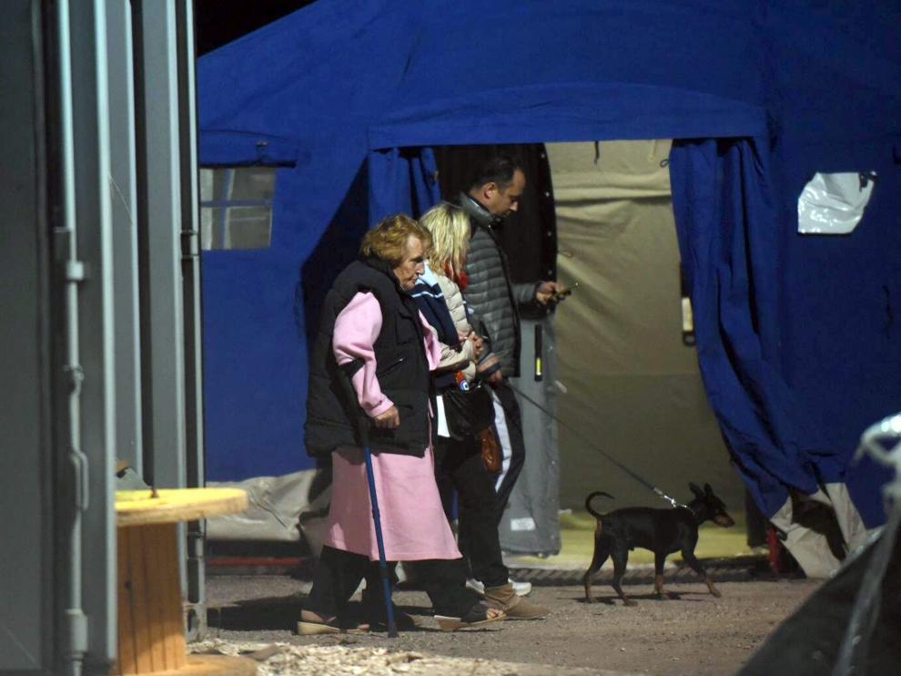 Afectados y voluntarios caminan junto a una de las tiendas instaladas en la localidad de Pescara del Tronto.