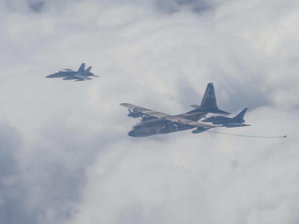 Un avión Hércules C-130 despliega la manguera para suministrar combustible a un Eurofighter y un F-18 (a la izquierda).