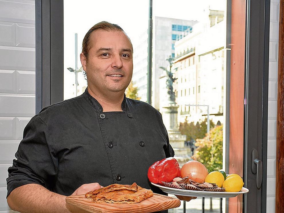 José Miguel Giménez, de La Pulpería, con una empanada de zamburiñas y con los ingredientes que ha utilizado.