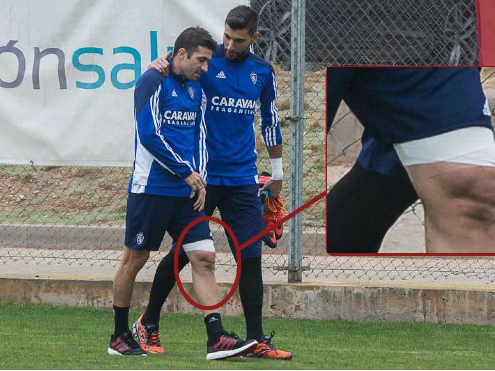 Cani, junto a Ratón, sale al césped de la ciudad deportiva en el entrenamiento de este domingo