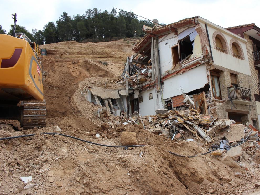 Retirada de escombros y tierra deslizada de Pui Pinos, junto a una de las casas destrozadas.