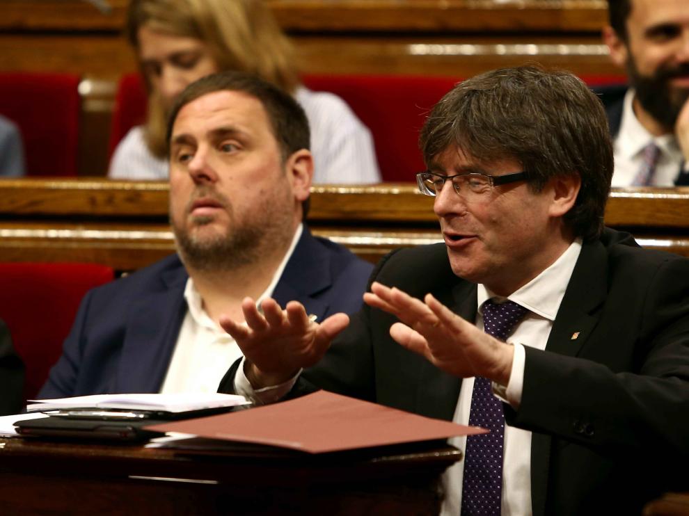 El presidente de la Generalitat, Carles Puigdemont (d), junto al vicepresidente del Govern y conseller de Economía, Oriol Junqueras