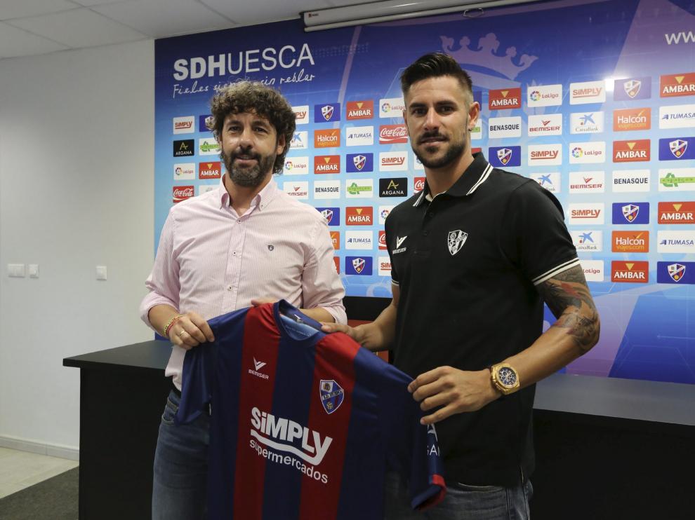 Luso Delgado posa con la camiseta del Huesca junto a Emilio Vega.