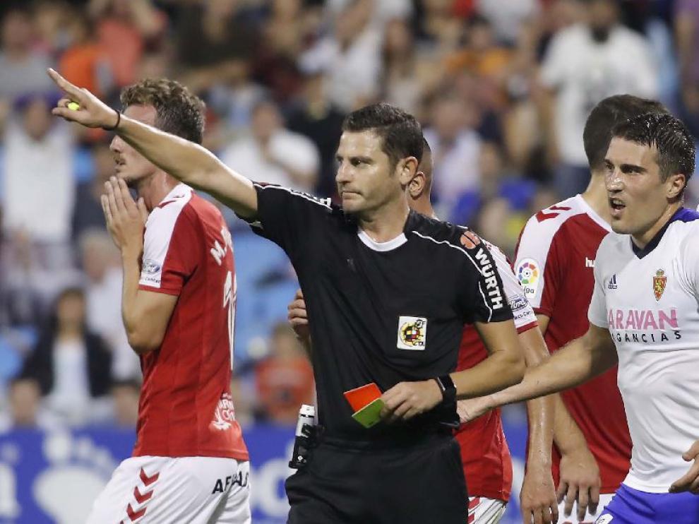 Figueroa Vázquez, junto a Zapater, tras decidir la expulsión de Borja Iglesias en la primera parte del Real Zaragoza-Nástic de este domingo.