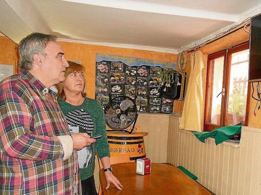 Jesús y Milagros Santo Tomás comprueban en el bar que la televisión no recibe señal.