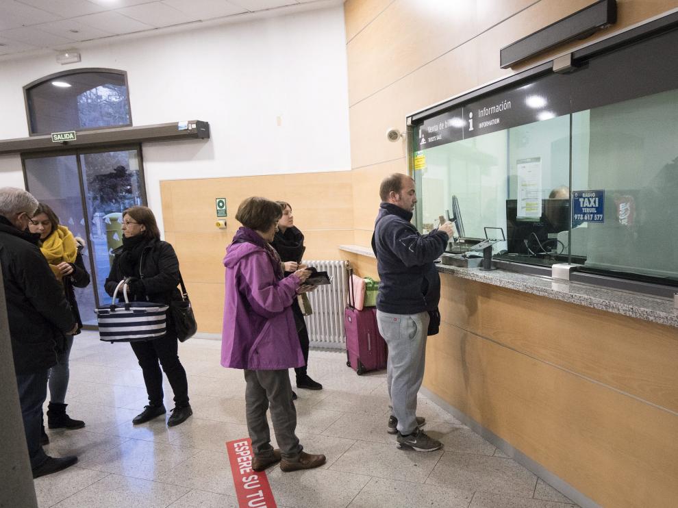 Varios viajeros esperan para comprar sus billetes en la estación de tren de Teruel