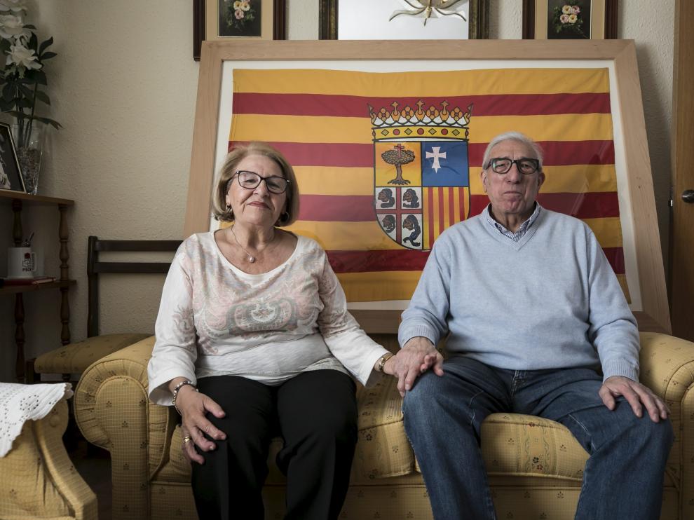 Miguel Dalmau y Herminia Blanco con la bandera que confeccionó ella hace cuatro décadas.