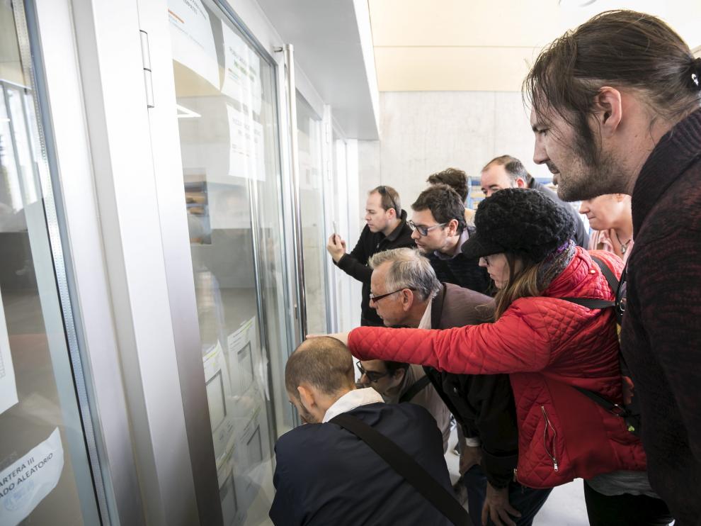 Familiares miran las listas provisionales de admitidos en el colegio Valdespartera III