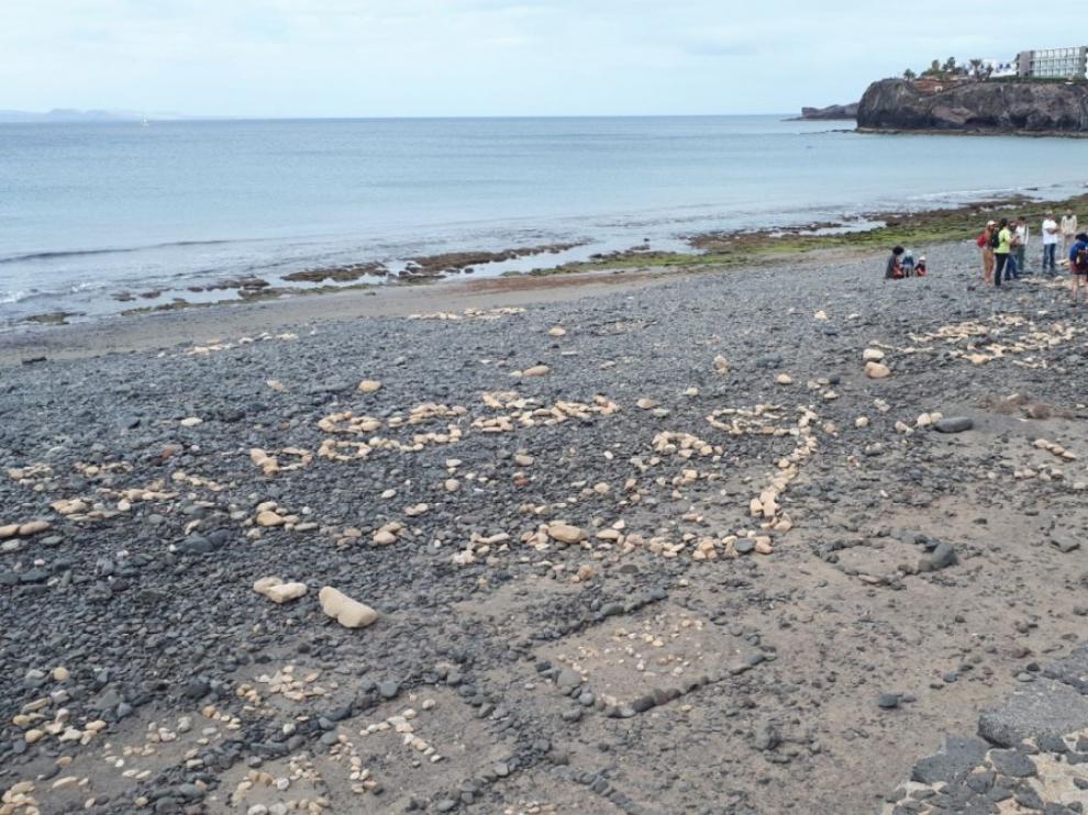 Un grupo de voluntarios del programa "Junt@s Somos Biosfera" recogiendo las construcciones de rocas en la playa de Las Coloradas