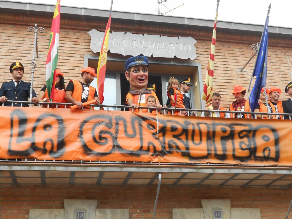 La peña 'La Gurrupea' durante el pregón y con el cabezudo que ha regalado al municipio.