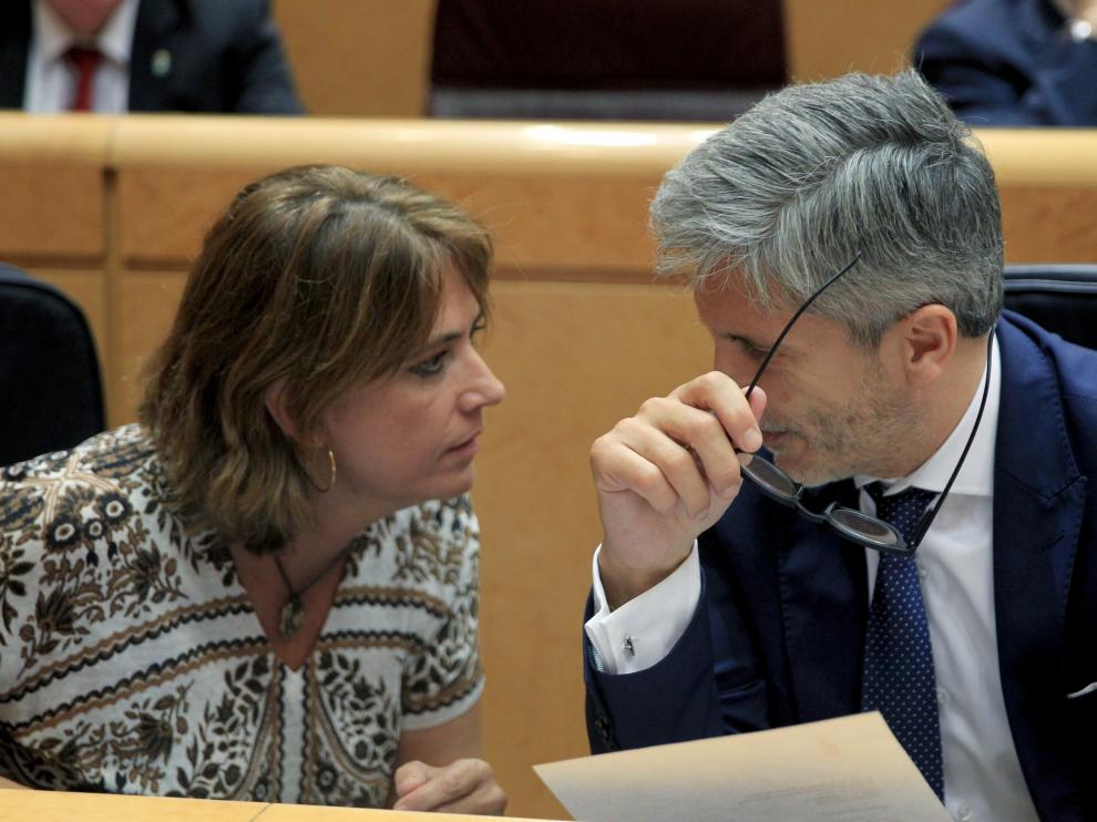La ministra de Justicia, Dolores Delgado (i), conversa con el ministro del Interior, Fernando Grande-Marlaska (d), durante el pleno del Senado celebrado hoy en Madrid, y en el que se debate la moción en la que el PP pide su reprobación.