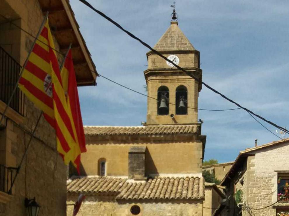 El alcalde, junto al ayuntamiento y con la parroquia al fondo.