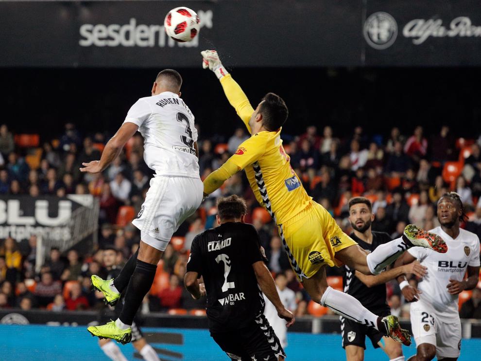 El defensa portugués del Valencia, Rúben Vezo (i), remata ante el guardameta del CD Ebro, Salva de La Cruz (d), durante el encuentro de vuelta de dieciseisavos de final de la Copa del Rey jugado esta noche en el campo de Mestalla, en Valencia.