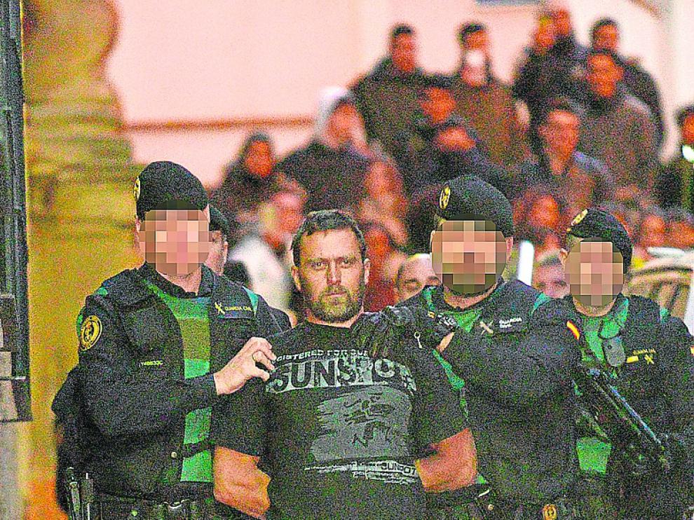 Esposado cuando sale de la celda. El preso preventivo de máxima seguridad Norbert Feher (en la foto aparece cuando lo trasladaron al juzgado el año pasado) sale siempre esposado de la celda de aislamiento y lo conducen dos funcionarios con equipo antidisturbios. Los grilletes no se le retiran hasta que regresa a su habitáculo, como exige la ley penitenciaria.