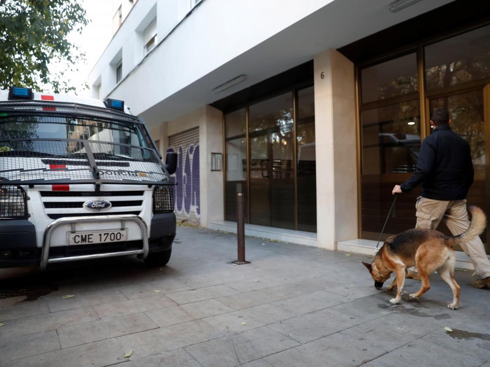 Un vehículo de los mossos, ante uno de los edificios de Barcelona que han sido registrado.