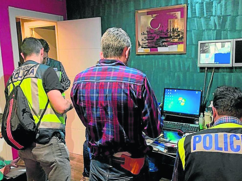 Los agentes que participaron en la operación, durante el registro del prostíbulo.