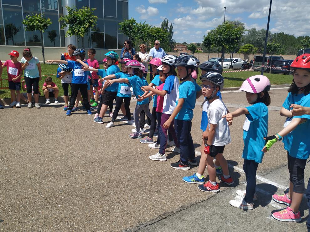 Los participantes en el segmento de ciclismo esperan la entrega de los testigos.