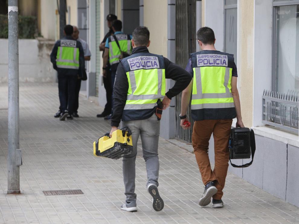 Agentes de Policía trabajan en la vivienda donde fue encontrado el cuerpo de la mujer.