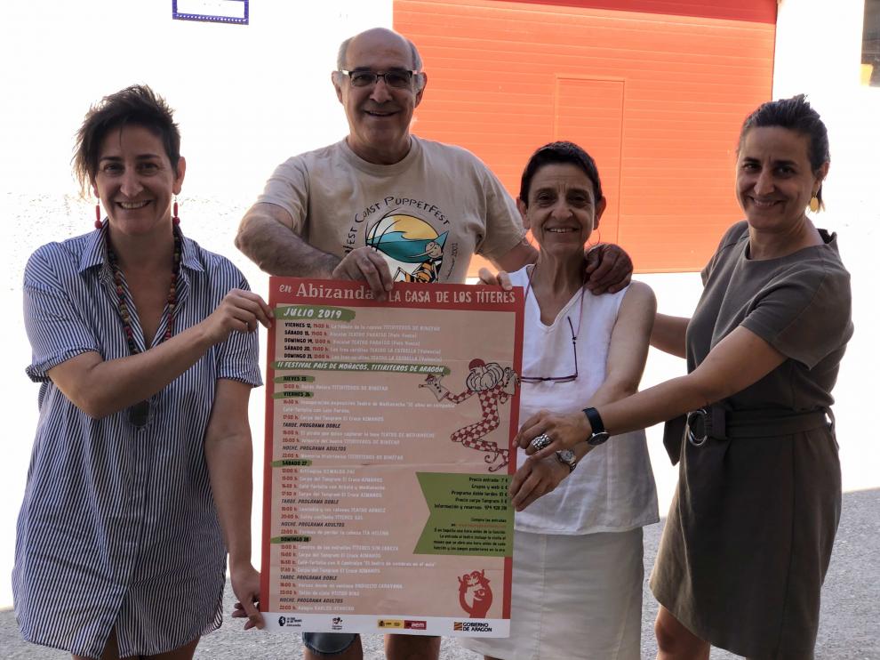 Los Titiriteros de Binéfar con el cartel de la programación de julio.