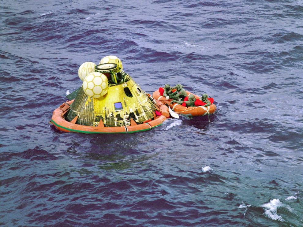 FFM101. AT SEA (), 17/07/2019.- A handout photo made available by the National Aeronautics and Space Administration (NASA) shows the members of the 'Apollo 11' crew wait for pickup by a helicopter from the 'USS Hornet', the prime recovery ship for the historic lunar landing mission at sea on 24 July 1969 (issued 17 July 2019). The fourth man in the life raft is a U.S. Navy underwater demolition team swimmer. All four men are wearing biological isolation garments.The year 2019 marks the 50th anniversary of the first moon landing, an event seen as the peak of the United States' space program of the 1960s which put an end to the so-called 'Race to Space' between the Cold War rivals the US and the Soviet Union, that once was triggered by the USSR's 04 October 1957 launch of the 'Sputnik 1' satellite. NASA astronaut Neil Armstrong made history when he stepped out of the Apollo 11's 'Eagle' landing module on 21 July 1969 and left the first human footprints on the moon. EFE/EPA/NASA HANDOUT E