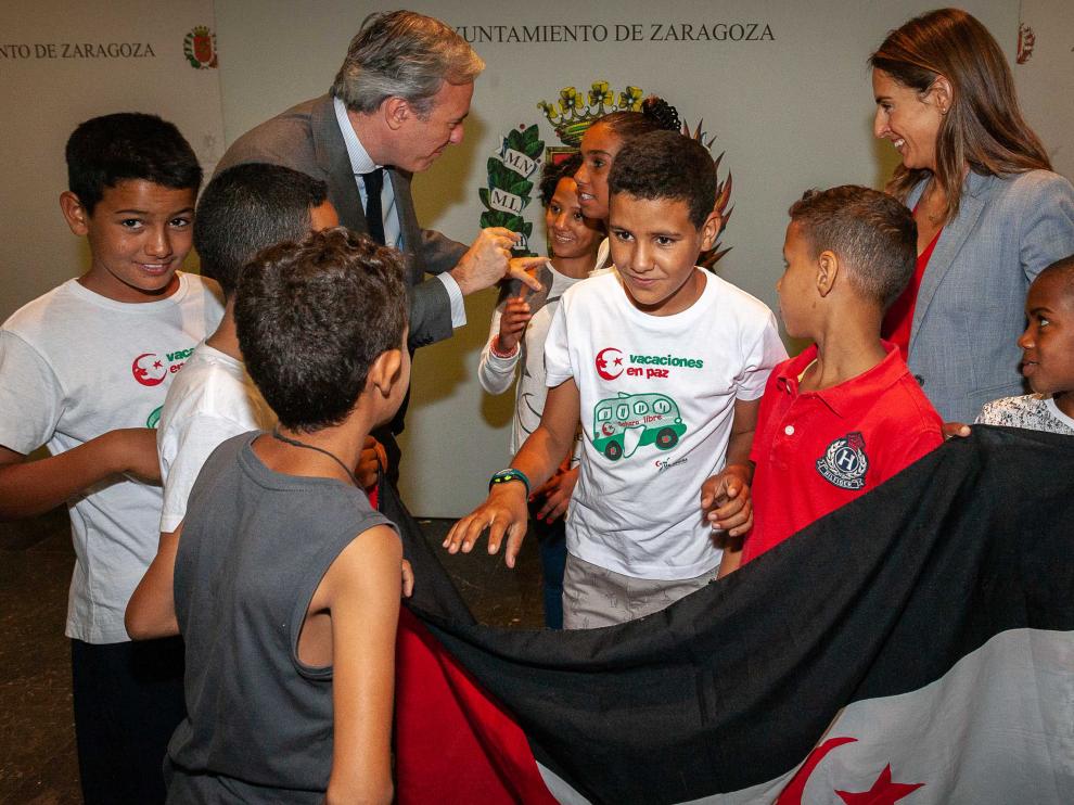 El alcalde de Zaragoza, Jorge Azcón, charla con varios de los niños llegados a la capital