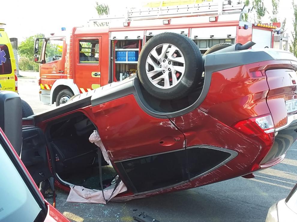 Un vehículo volcado en la avenida de la Ciudad de Soria, donde se ha producido el accidente.