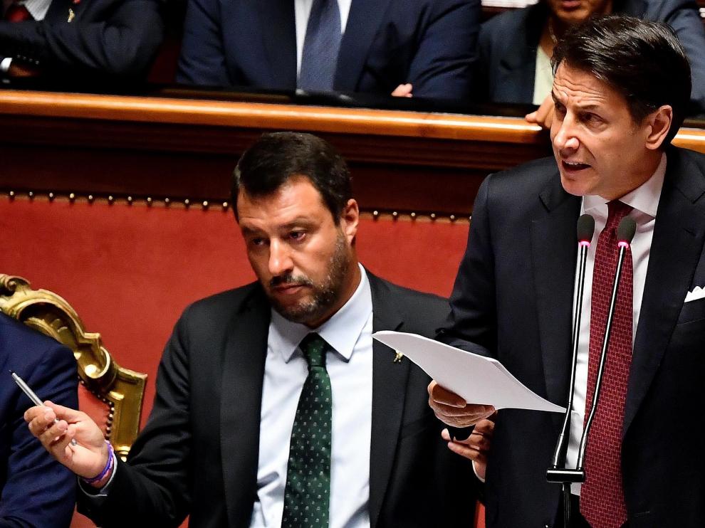 Rome (Italy), 20/08/2019.- Italian Prime Minister Giuseppe Conte (R) is flanked by Deputy Prime Ministers Matteo Salvini (L) as he addresses the Senate in Rome, Italy, 20 August 2019. Conte in his address to the senate called bringing about the government crisis irresponsible. Deputy Premier and Interior Minister Matteo Salvini and his party League pulled out from government and caused a political crisis a week ago. Conte said that the government has come to an end and that he would resign. (Italia, Roma) EFE/EPA/ETTORE FERRARI Italian Premier Giuseppe Conte addresses the Senate