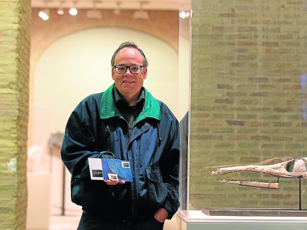 José Manuel Clúa, con los sellos y postales de Ricla al lado del fósil del cocodrilo