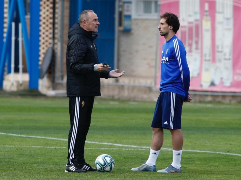 Víctor Fernández e Íñigo Eguaras, este martes durante la charla mantenida entre ambos en el césped del campo de entrenamientos del Real Zaragoza.