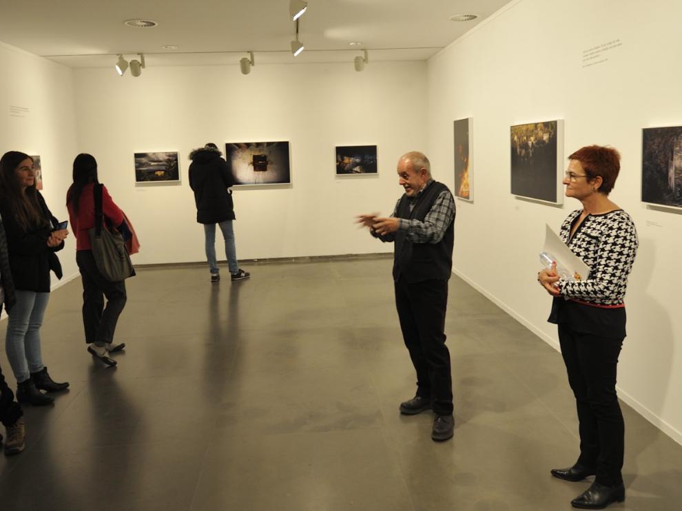 El fotógrafo José Manuel Navia, durante una visita guiada a la exposición junto a la diputada provincial Maribel de Pablo.