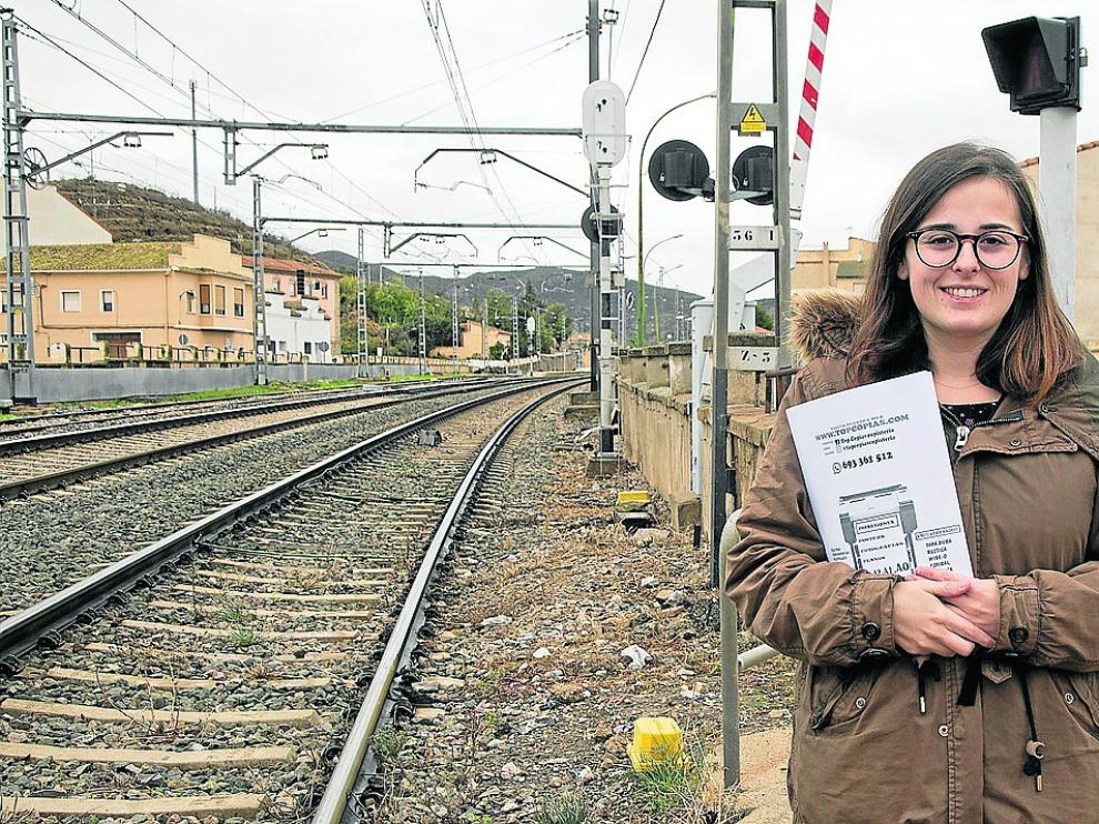 Lierni García, con una carpeta con las firmas que han recogido, en el paso a nivel de Ricla.
