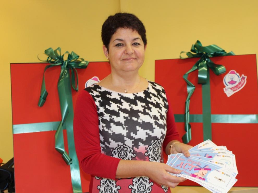 La gerente de la ACT, Ana Tarazona, posa con los vales del premio para el primer bebé del año.