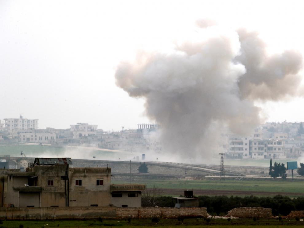 Smoke rises after an air strike in Saraqeb in Idlib province