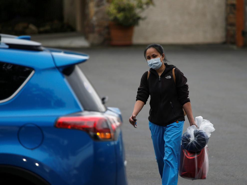 A worker in scrubs leaves the Life Care Center of Kirkland