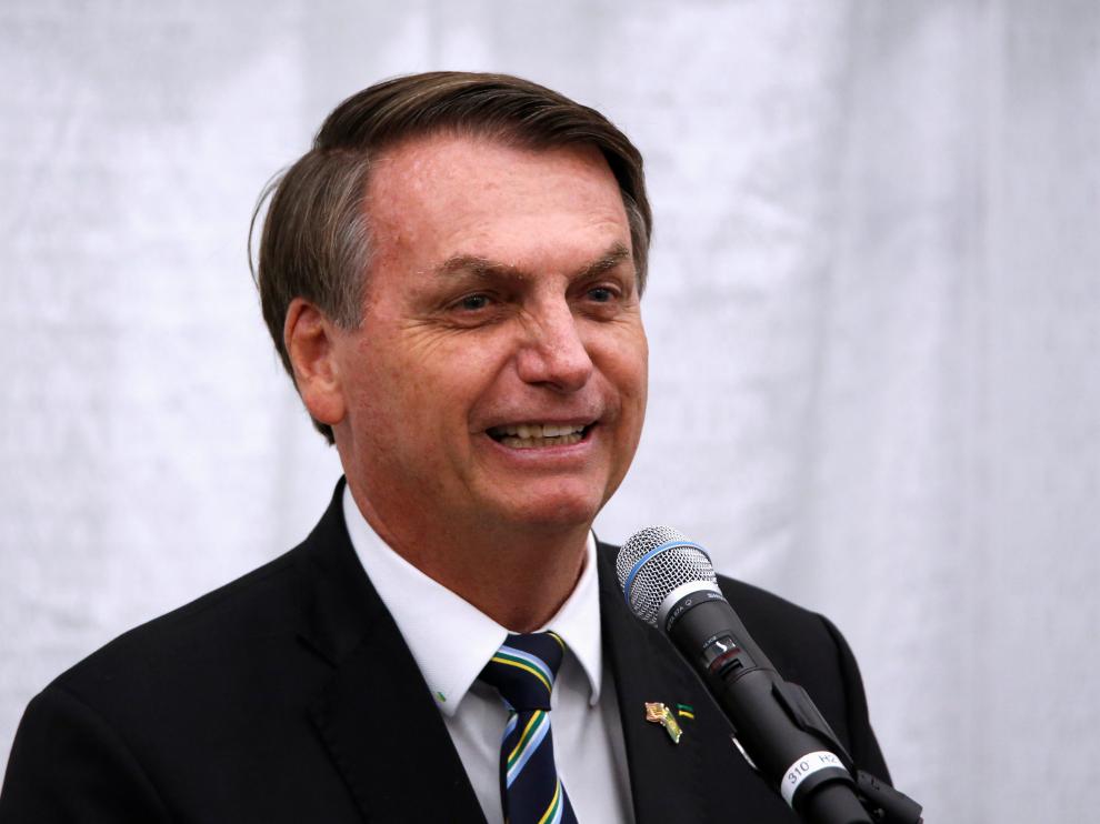 Brazilian President Jair Bolsonaro smiles as he speaks during a meeting with the Brazilian community at The Miami Dade College Auditorium, in Miami