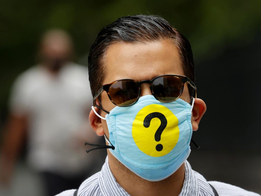 Man wears a protective face mask decorated with a question mark during outbreak of the coronavirus disease (COID-19) in New York