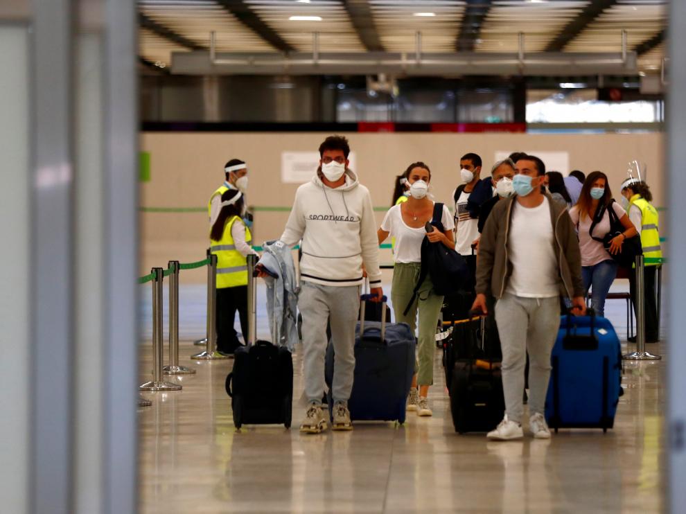 Passengers arrive at Adolfo Suarez Barajas airport in Madrid
